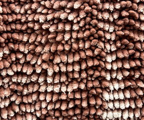 Brown terry carpet as an abstract background. Texture