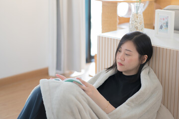 wellness and wellbeing concept with asian man sit and relax and read in livingroom