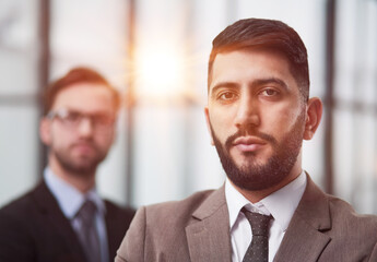 Fototapeta premium Portrait male worker looking at camera, positive employee posing for company business directory with co-workers