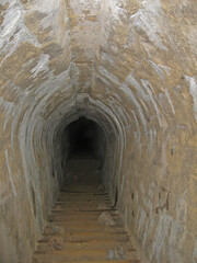 Going down by Dark narrow concrete underpass, underground Stone tunnel Inside the Vladivostok...