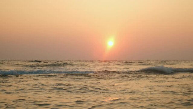 Beautiful nature background.Ocean waves at sunset.
