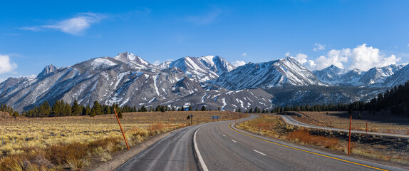 Panoramic view of Eastern Sierra mountains , scenic highway heading towards the mountains.