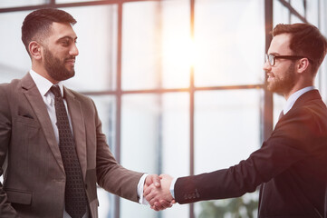 Fototapeta premium director of the company, glad to meet his new colleague. Handshake and new employee concept.