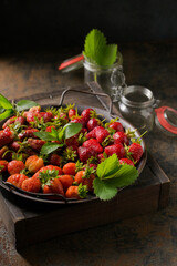 Different varieties of strawberries on a metal tray