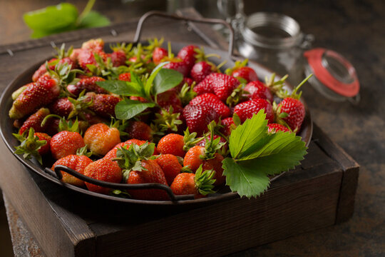 Different varieties of strawberries on a metal tray