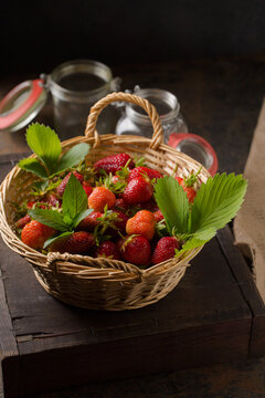 Different varieties of strawberries in a vine basket