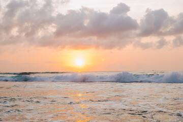 Fototapeta na wymiar Gentle peach sunset on the background of the ocean. Beautiful nature background.