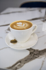 Coffee cup with latte on the table