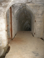 Dark narrow concrete underpass, underground Stone tunnel Inside the Vladivostok fortress, Russia
