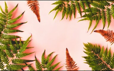 Creative layout made of various tropica palm and fern leaves on pastel pink background