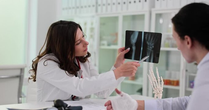 Doctor examined patient with wrist pain and x-ray of hand