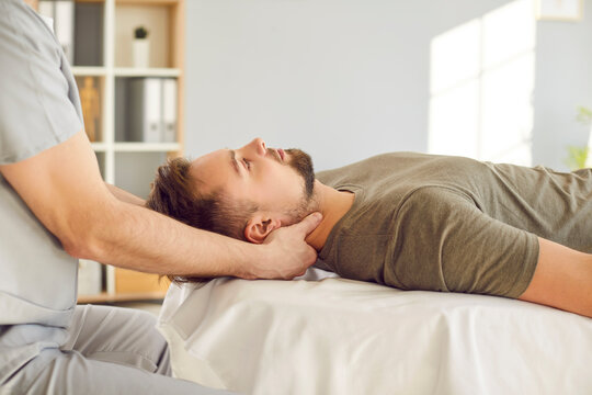 Head and neck massage, manual therapy rehabilitation, physical therapist doing manipulative therapy. Male medical session to relieve tension, reduce headache, increase relaxation and body health