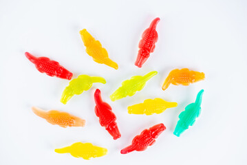 Swedish candy, chewy candies in the shape of crocodiles on a white background. Top view.