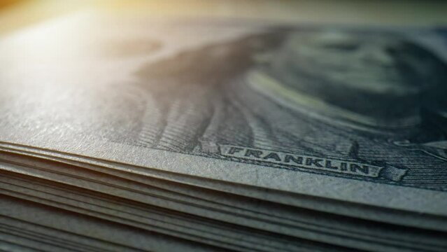 A macro shots capture the allure of American one hundred dollar bills, a symbol of prosperity. Cash flow and Payment concept. Paper currency Background. 4K.

