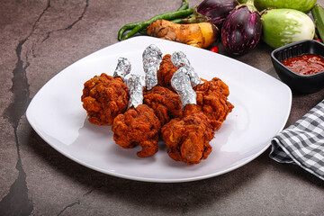 Indian cuisine glazed chicken lollipop