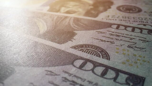 Explore the intricate patterns on 100 American dollar bills in stunning macro video. Sustainable finance regulations concept. Cash money Background. 4K HDR.
