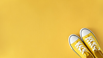 Yellow Sneakers on Yellow Background. Top View. Perfect for Spring and Summer.
