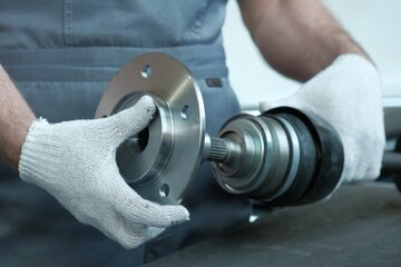 The hub of the front wheel is in the hands of an auto mechanic. Inspection of new spare parts,...