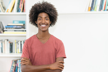 Laughing black male young adult with crossed arms