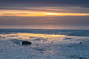 Tranquility on the Wadden Sea during sunset. It is low tide, causing much of the Wadden (UNESCO...