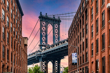 Obraz premium Wonderful sunrise or sunset in Dumbo the trendy Brooklyn neighborhood with picturesque views of the Manhattan skyline and its bridge, famous in New York City (USA).