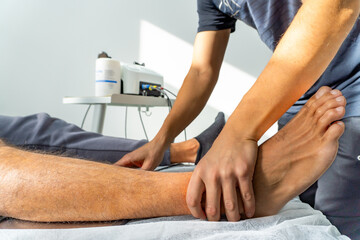 close up of a physiotherapist placing the feet of a patient