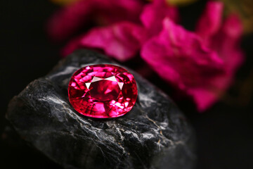 Red and white diamond gemstone shining brightly against a rich red background