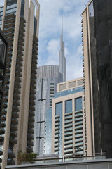 Futuristic and modern commercial and residential highrise tower skyscraper architecture with glass facades and clean lines in downtown Dubai, United Arab Emirates for millionaires and high society