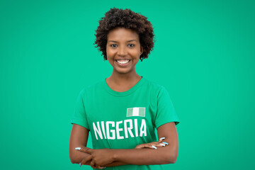 Laughing football supporter from Nigeria with green jersey