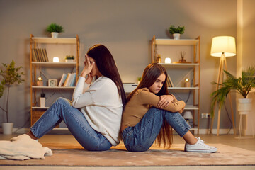 Mother and daughter conflict, miscommunication sitting back to each other. Adolescent separation,...