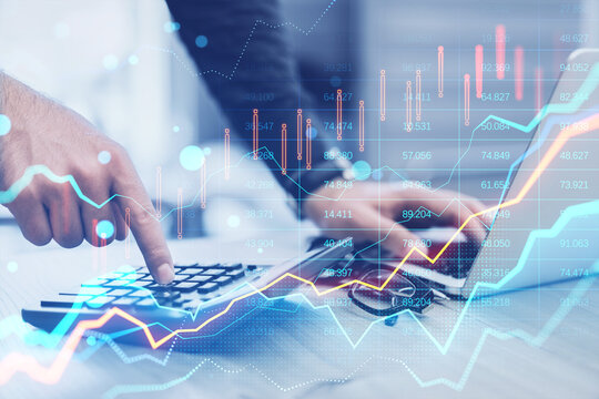 Close up of hands using laptop and calculator with glowing forex chart on blurry bokeh background. Trade, finance and market concept. Toned image. Double exposure.