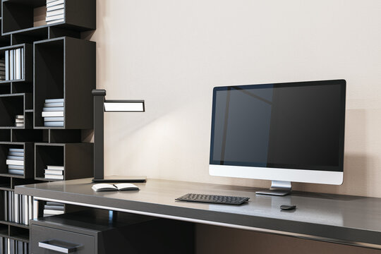 Close up of simple designer office interior with creative wooden bookcase, empty computer monitor and other items. Mock up, 3D Rendering.