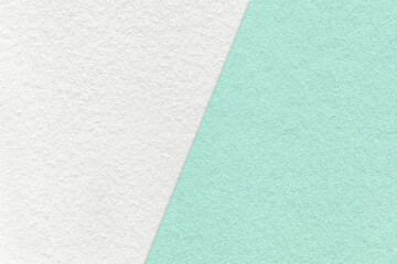 Texture of craft white and light cyan paper background, half two colors, macro. Vintage kraft mint...