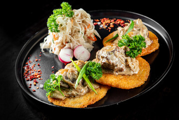 potato pancakes with meat, mushrooms and creamy sauce