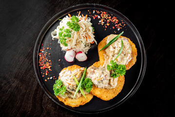 potato pancakes with meat, mushrooms and creamy sauce