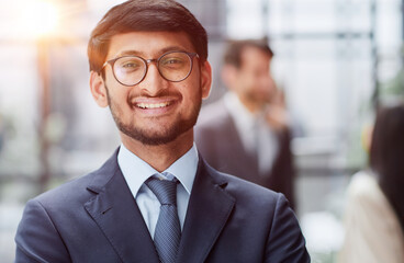 Fototapeta premium Handsome young business man standing confident in the office