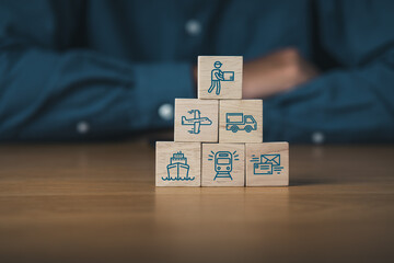 Businessman and wooden blocks of logistics icons and supply chain management.