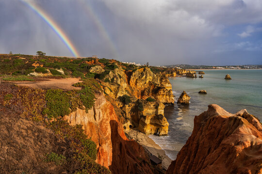 Portugal, Algarve, Lagos, Double rainbow over coastal cliffs