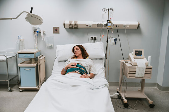 Pregnant woman lying on bed in delivery room