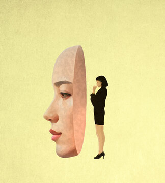 Thoughtful woman standing behind oversized female mask