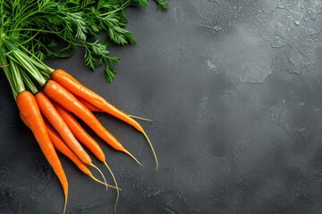 Fresh carrot bunch with copy space on dark gray textured background - obrazy, fototapety, plakaty
