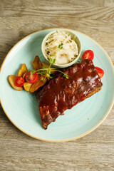 BBQ pork ribs with steak potatoes and cabbage salad