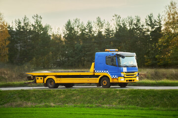 Fototapeta na wymiar Empty tow truck transporter on highway