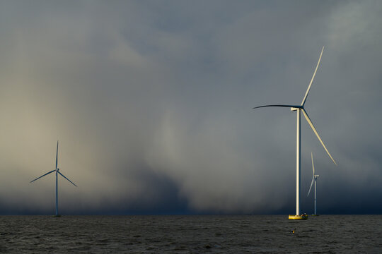 Netherlands, Flevoland, Lelystad, Thick clouds over offshore wind farm in IJsselmeer