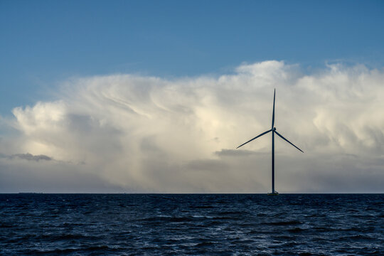 Netherlands, Flevoland, Lelystad, Thick clouds over offshore wind farm in IJsselmeer