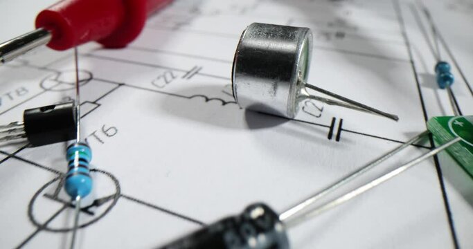 Various electronic parts or components on the background of printed circuit board diagram with resistors and capacitors