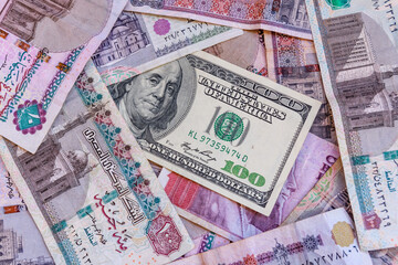 American one hundred dollar banknote on heap of the egyptian money