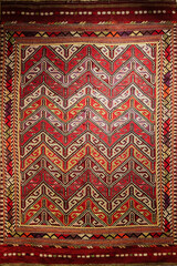 Traditional Turkish carpet. Old wool rug, geometrical patterns, vertical. Istanbul, Turkey