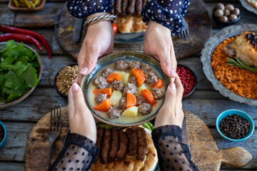 Meatball soup with carrot and potatoes named ekşili terbiyeli sulu köfte or eksili kofte 