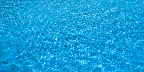 The background of the blue sea. On a summer day, the sunlight hits the sparkling sea.